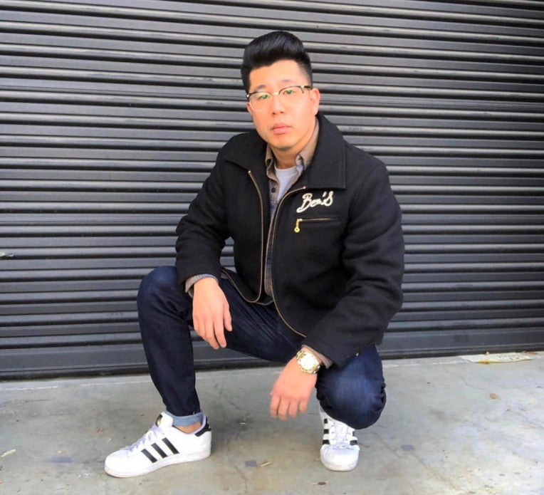 Joe Jitsukawa crouching in front of a roller door